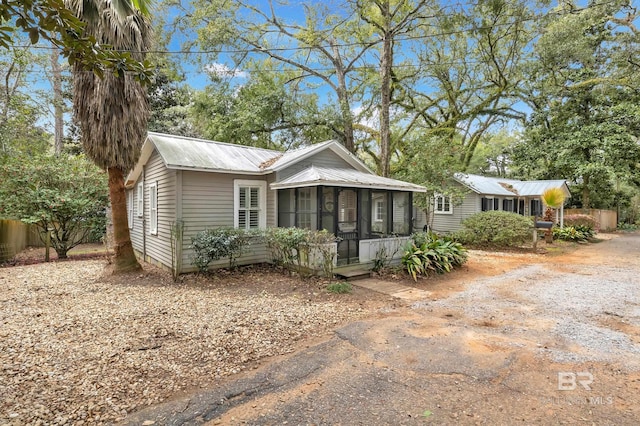 view of front of house with a sunroom and metal roof