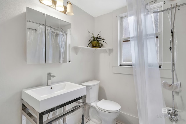 full bathroom with toilet and vanity