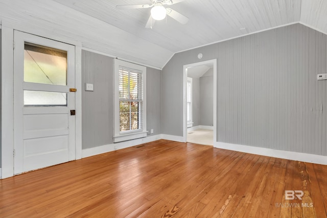 foyer featuring a ceiling fan, vaulted ceiling, baseboards, and hardwood / wood-style flooring