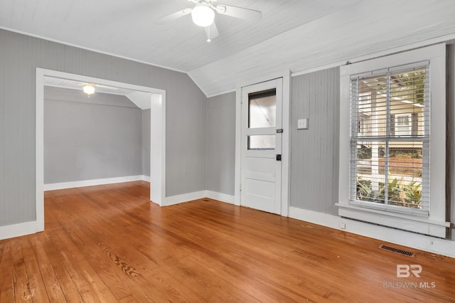 entrance foyer featuring vaulted ceiling, hardwood / wood-style floors, plenty of natural light, and visible vents