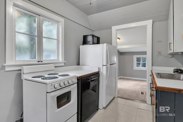 kitchen with vaulted ceiling, light countertops, a sink, and black appliances
