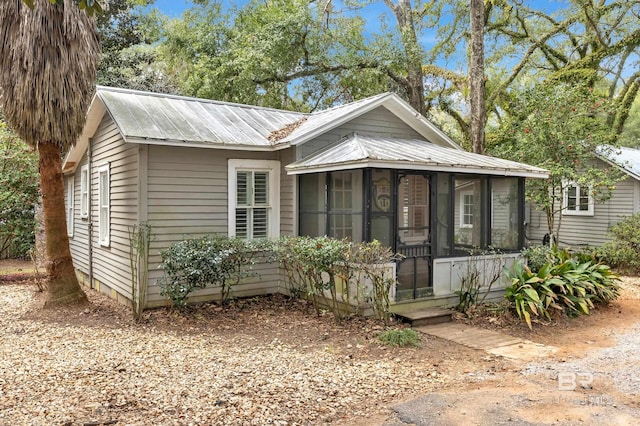 view of front of home with a sunroom and metal roof