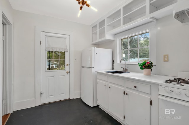 kitchen with white appliances, a wealth of natural light, open shelves, and a sink