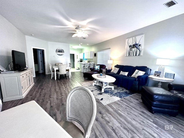 living room with ceiling fan and dark hardwood / wood-style flooring