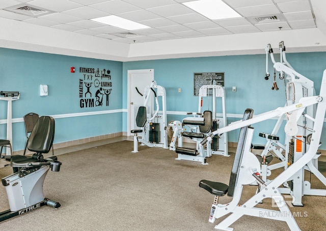 workout area featuring visible vents, a paneled ceiling, and carpet floors