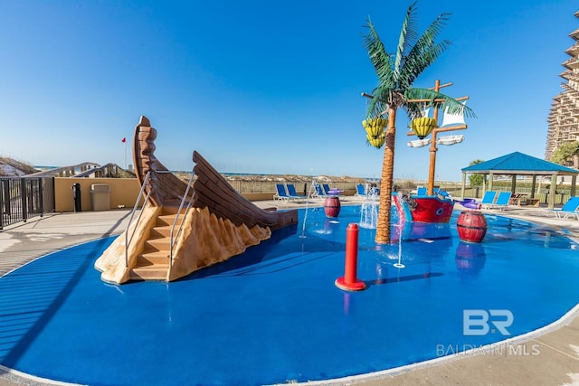 view of playground featuring a gazebo and fence