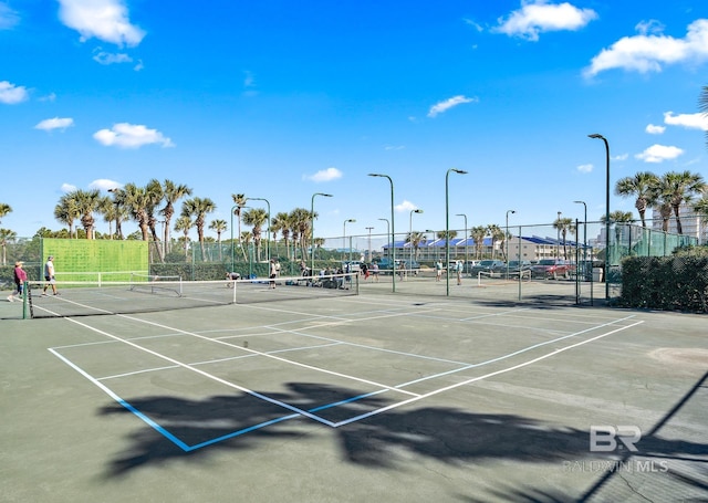 view of sport court featuring fence