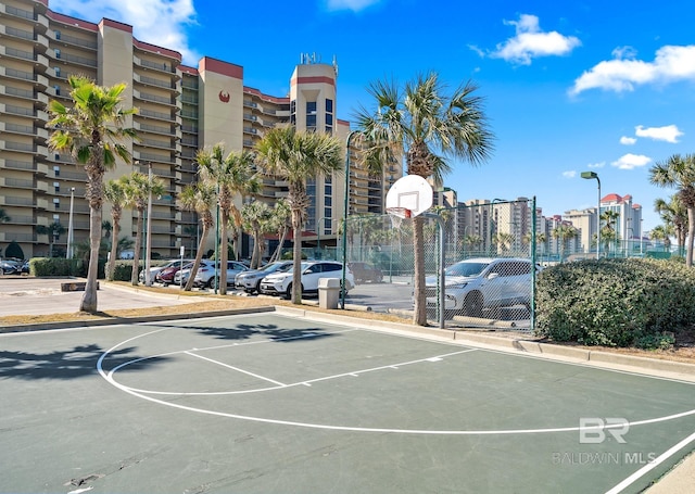 view of basketball court featuring community basketball court and fence