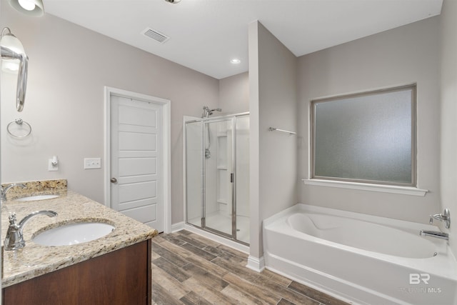 bathroom featuring separate shower and tub, vanity, and wood-type flooring