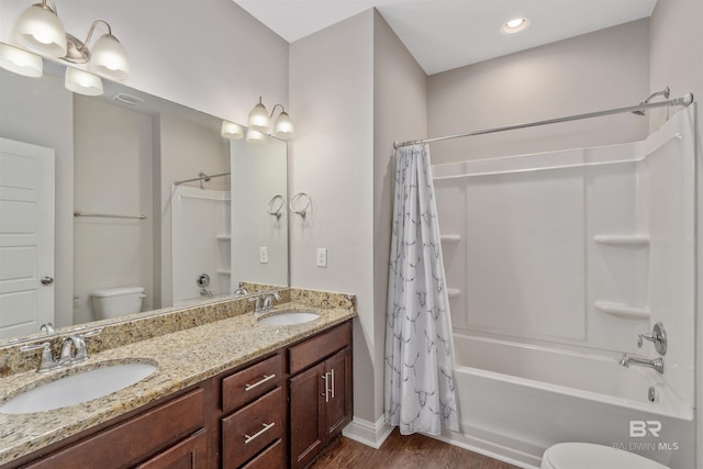 full bathroom featuring hardwood / wood-style floors, vanity, toilet, and shower / bathtub combination with curtain