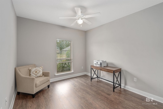 living area featuring ceiling fan and dark hardwood / wood-style flooring