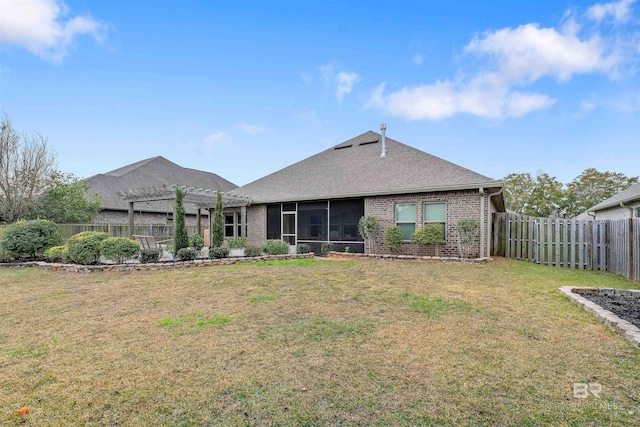 rear view of house featuring a pergola and a yard