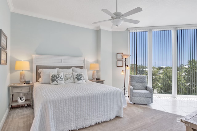 bedroom with ceiling fan, ornamental molding, expansive windows, a textured ceiling, and light carpet