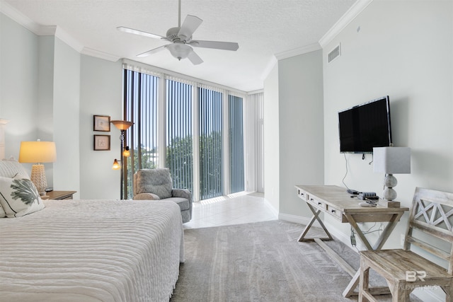 bedroom with ornamental molding, floor to ceiling windows, carpet floors, and a textured ceiling