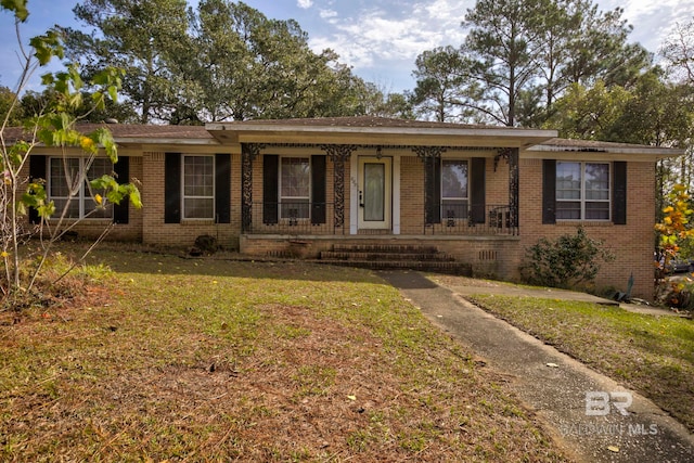 single story home with a front lawn and covered porch