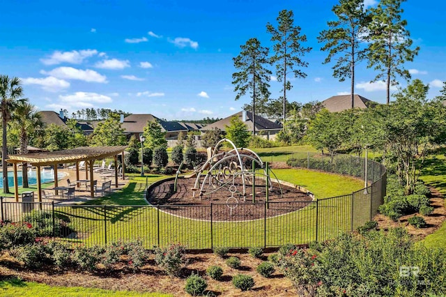 view of play area featuring a lawn, a patio, and a pergola