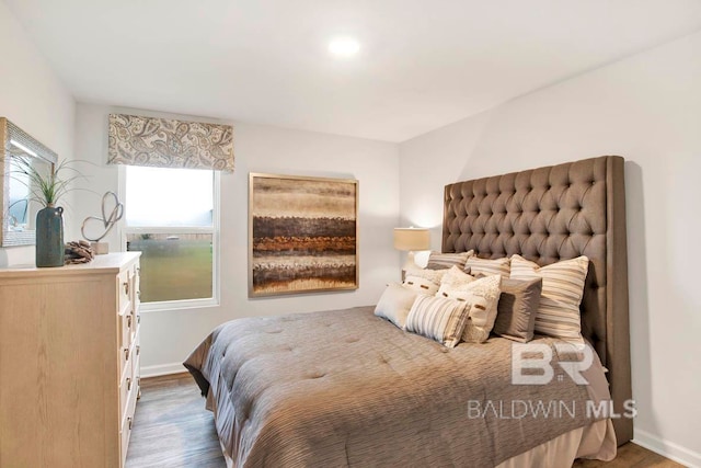 bedroom featuring hardwood / wood-style flooring and multiple windows