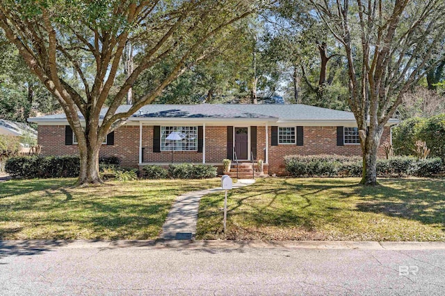 ranch-style home featuring brick siding and a front lawn