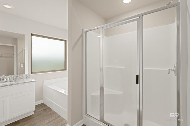 bathroom with separate shower and tub, vanity, and wood-type flooring