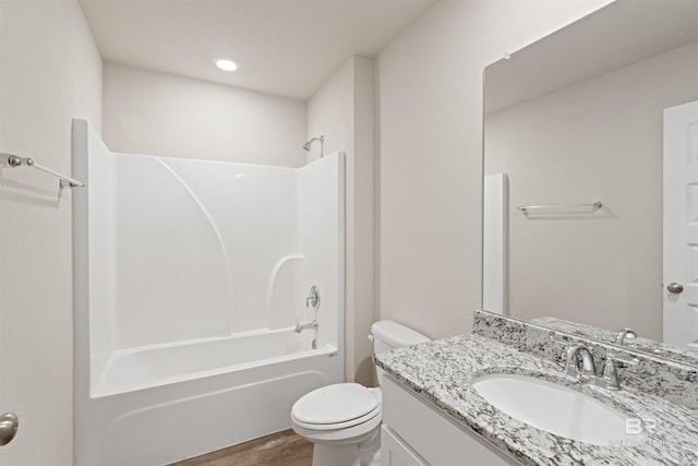 full bathroom with shower / bath combination, hardwood / wood-style flooring, toilet, and vanity