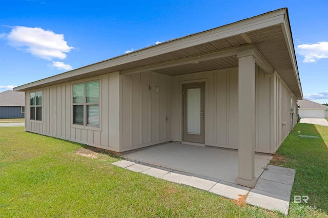 back of property with a patio area and a yard