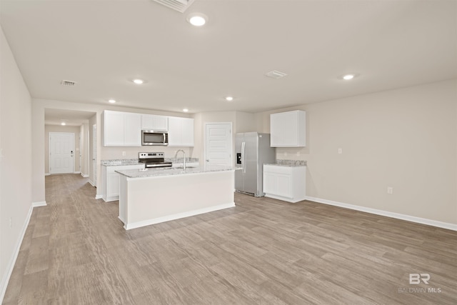 kitchen featuring white cabinets, light wood-type flooring, and appliances with stainless steel finishes