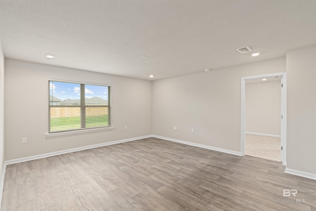 unfurnished room with wood-type flooring