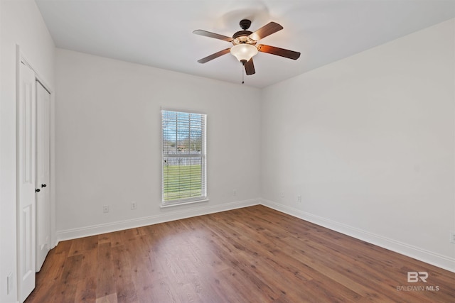 unfurnished bedroom featuring ceiling fan, baseboards, and wood finished floors