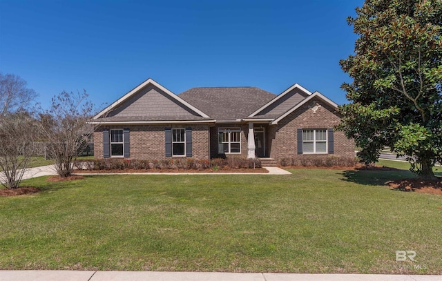 craftsman-style house featuring a front lawn and brick siding