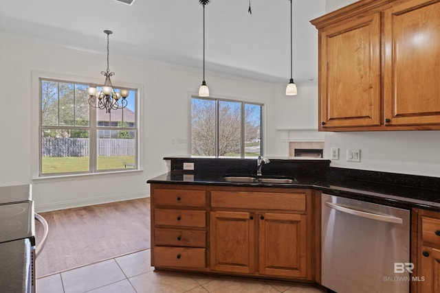 kitchen featuring a peninsula, range with electric cooktop, a sink, dishwasher, and brown cabinets