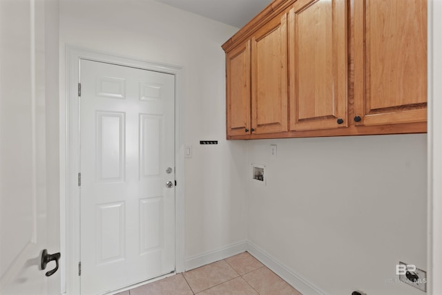 laundry area with hookup for a washing machine, baseboards, cabinet space, and light tile patterned flooring