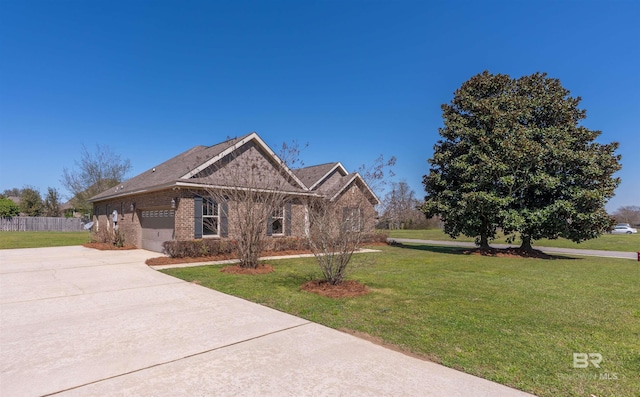 view of front of property with brick siding, fence, a front yard, a garage, and driveway