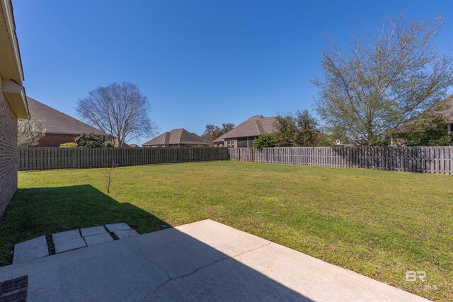 view of yard featuring a patio and a fenced backyard