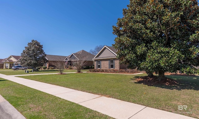 view of front of property featuring brick siding and a front yard