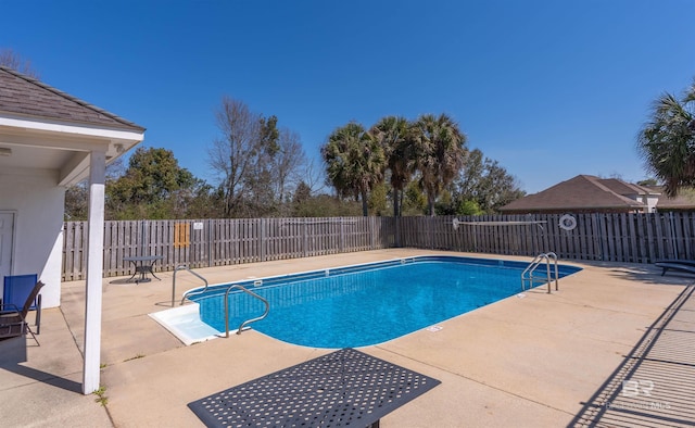 pool featuring a patio and fence