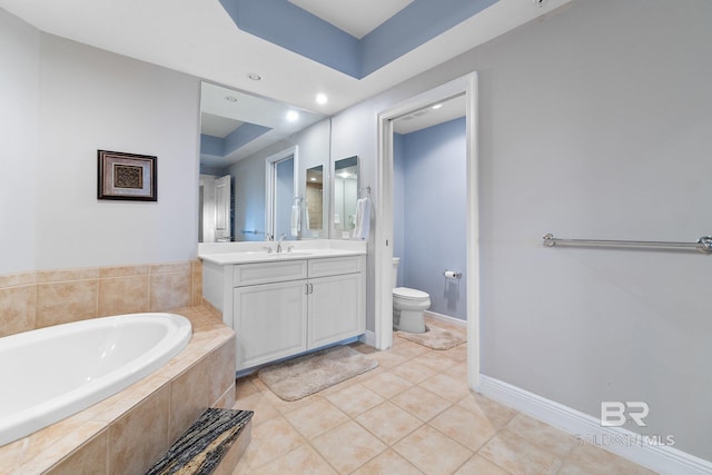 bathroom featuring a relaxing tiled tub, vanity, toilet, and tile patterned flooring