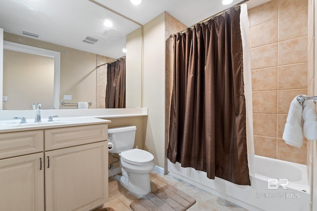 full bathroom featuring shower / bathtub combination with curtain, vanity, tile patterned flooring, and toilet