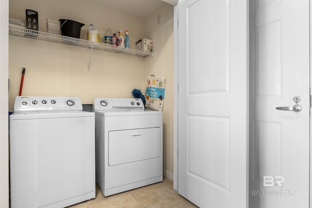 laundry area featuring light tile patterned flooring and independent washer and dryer