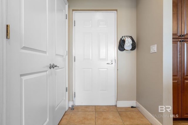 doorway featuring light tile patterned flooring