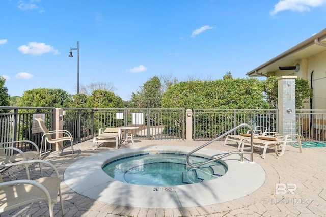 view of pool featuring a community hot tub and a patio