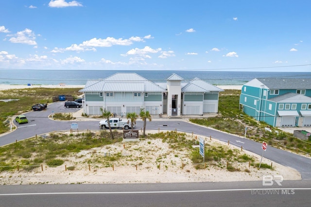 view of front facade with a view of the beach and a water view