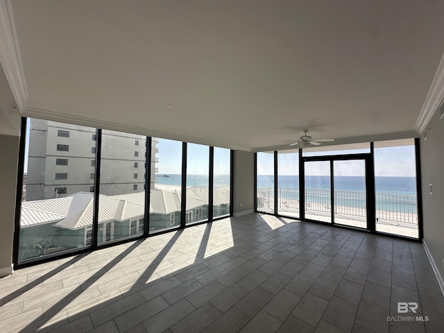 unfurnished sunroom with a water view, plenty of natural light, and a ceiling fan