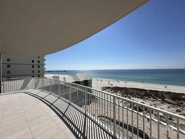 balcony with a view of the beach and a water view