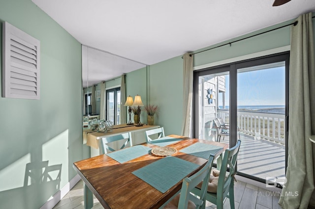 dining area featuring light wood-type flooring and a healthy amount of sunlight