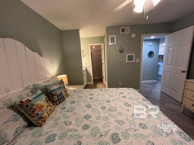 bedroom with dark hardwood / wood-style floors and ceiling fan