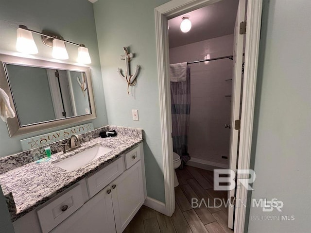 bathroom with vanity, toilet, wood-type flooring, and a shower with shower curtain