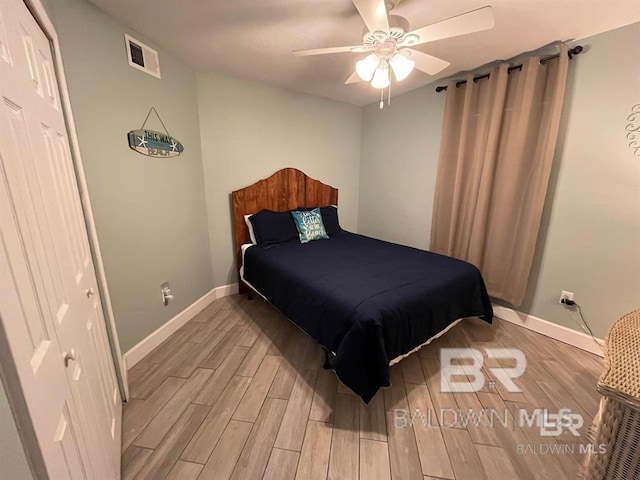 bedroom with ceiling fan and light hardwood / wood-style floors