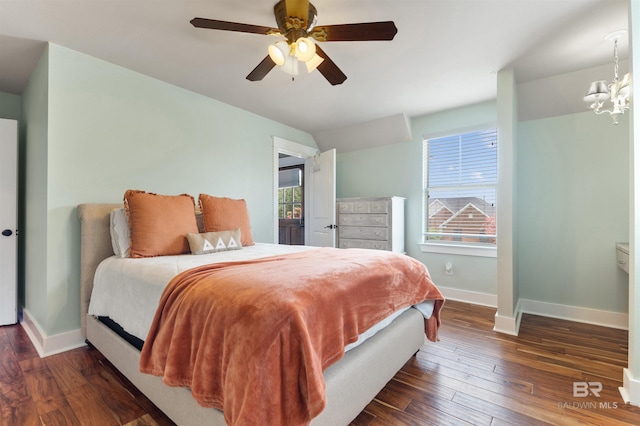 bedroom featuring ceiling fan with notable chandelier, multiple windows, and dark wood-type flooring