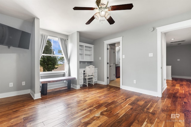 unfurnished living room featuring dark hardwood / wood-style flooring and ceiling fan