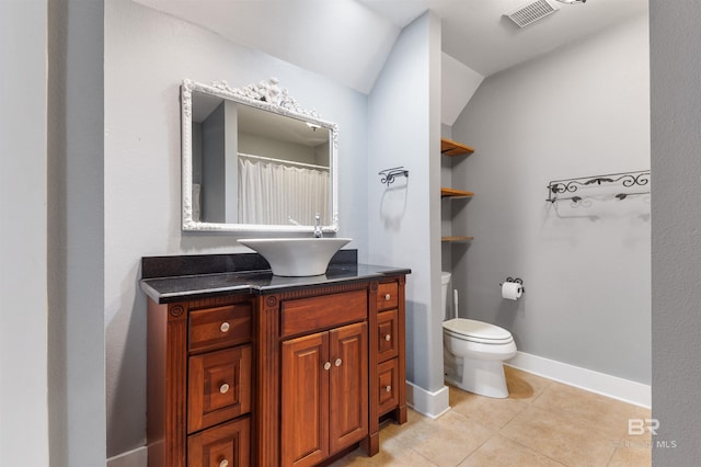 bathroom featuring tile patterned flooring, vanity, vaulted ceiling, and toilet